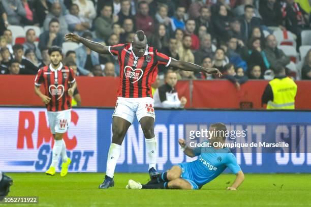 Valere Germain of Olympique de Marseille tackles Mario Balotelli of OGC Nice during the Ligue 1 match between OGC Nice and Olympique de Marseille at...