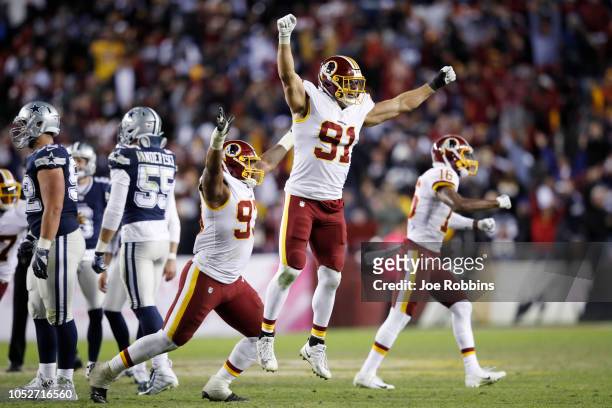Ryan Kerrigan and Jonathan Allen of the Washington Redskins react after a missed field goal by the Dallas Cowboys as time expired in the game at...