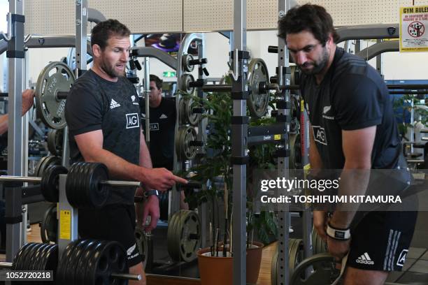 New Zealand's rugby team All Blacks' captain Kieran Read speaks to teammate Samuel Whitelock during a training session at a gym in Tokyo on October...