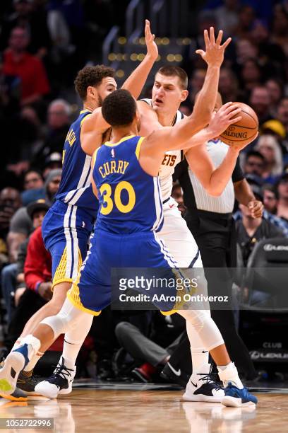 Klay Thompson of the Golden State Warriors and Stephen Curry guard Nikola Jokic of the Denver Nuggets during the second half of the Nuggets' 100-98...