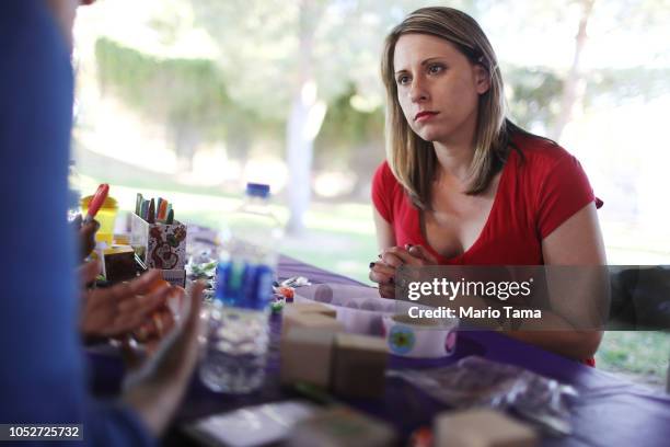 Democratic congressional candidate Katie Hill , speaks to a constituent at a Halloween carnival on October 21, 2018 in Lancaster, California. Hill is...