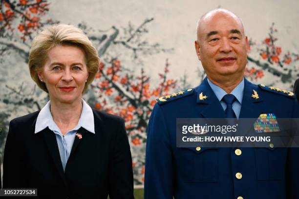 Germany's Defense Minister Ursula von der Leyen stands with China's Vice Chairman of the Central Military Commission Xu Qiliang at the Ba Yi Building...