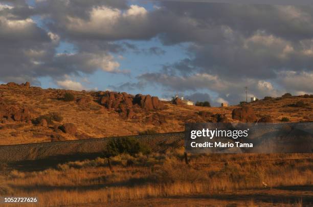 Structures sit atop a hillside on October 21, 2018 near Palmdale, California. The desert city of Palmdale sits in California's 25th District where...