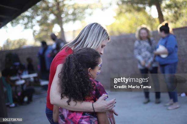 Democratic congressional candidate Katie Hill , C, hugs a girl at a campaign Halloween carnival event on October 21, 2018 in Lancaster, California....