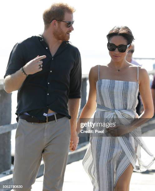 Meghan, Duchess of Sussex and Prince Harry, Duke of Sussex walk along Kingfisher Bay Jetty during a visit to Fraser Island on October 22, 2018 on...