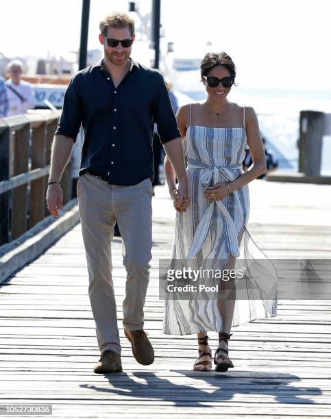 Meghan, Duchess of Sussex and Prince Harry, Duke of Sussex walk along Kingfisher Bay Jetty during a visit to Fraser Island on October 22, 2018 on...