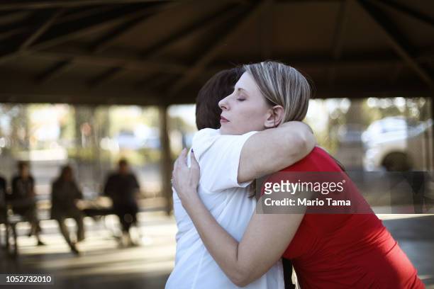 Democratic congressional candidate Katie Hill , R, hugs a supporter at a campaign Halloween carnival on October 21, 2018 in Lancaster, California....