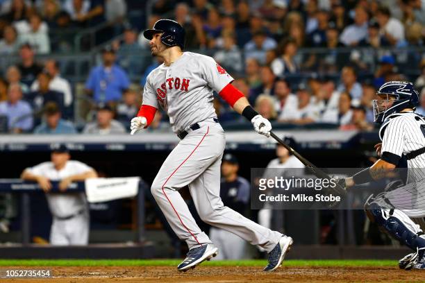 Martinez of the Boston Red Sox hits a sacrifice fly RBI to score Andrew Benintendi against CC Sabathia of the New York Yankees during the third...