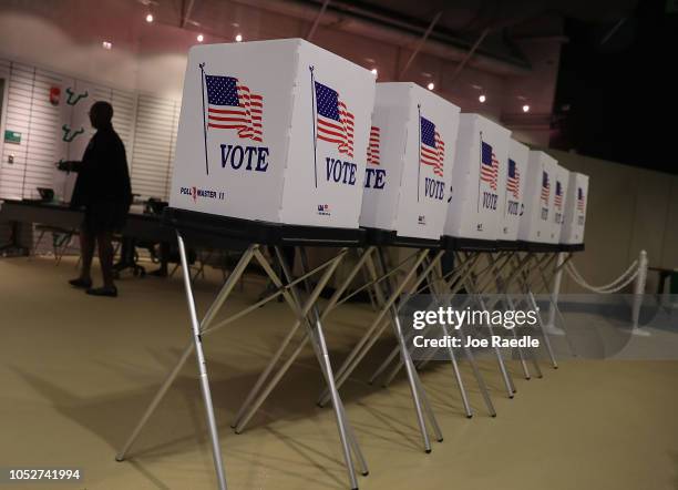 Voting booths are setup at the Yuengling center on the campus of University of South Florida as workers prepare to open the doors to early voters on...