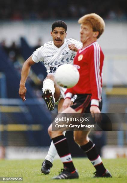 Spurs full back Chris Hughton clears the ball past the advances of Manchester United player Gordon Strachan during a First Division match at White...