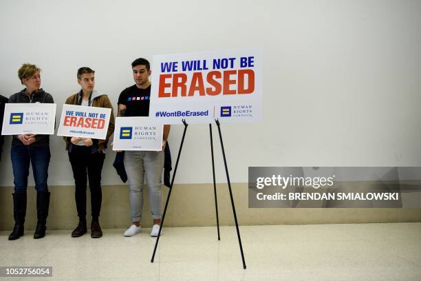 People wait to hold a press conference at the Human Rights Campaign before activists march for the LGBTQ community, during a protest of the Trump...