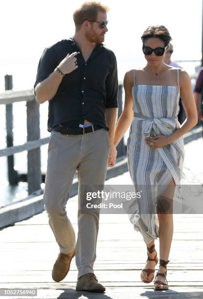 Meghan, Duchess of Sussex and Prince Harry, Duke of Sussex walk along Kingfisher Bay Jetty during a visit to Fraser Island on October 22, 2018 on...