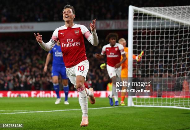 Mesut Ozil of Arsenal celebrates after he scores his sides first goal during the Premier League match between Arsenal FC and Leicester City at...