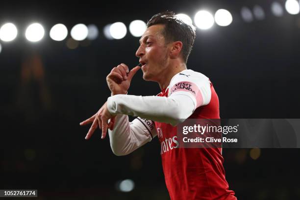 Mesut Ozil of Arsenal celebrates after he scores his sides first goal during the Premier League match between Arsenal FC and Leicester City at...