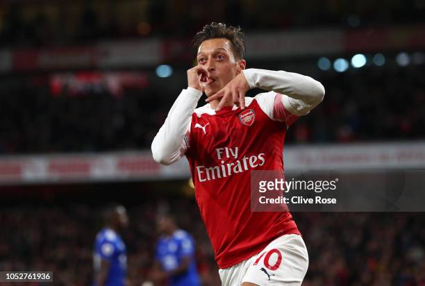 Mesut Ozil of Arsenal celebrates after he scores his sides first goal during the Premier League match between Arsenal FC and Leicester City at...