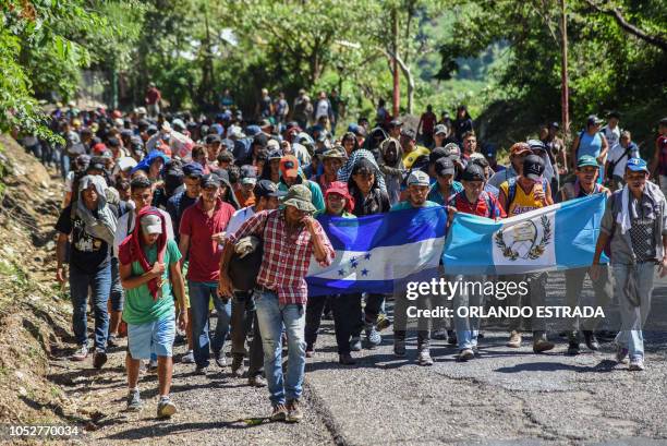 Honduran migrants take part in a new caravan heading to the US with Honduran and Guatemalan national flags in Quezaltepeque, Chiquimula, Guatemala on...