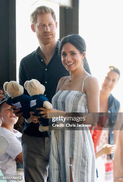 Prince Harry, Duke of Sussex and Meghan, Duchess of Sussex walk along the picturesque Kingfisher Bay Jetty on October 22, 2018 in Fraser Island,...