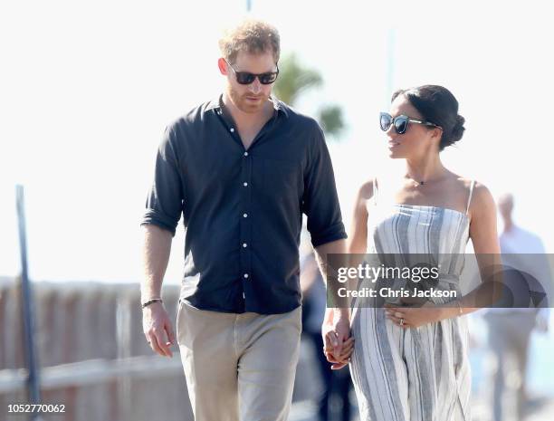 Prince Harry, Duke of Sussex and Meghan, Duchess of Sussex walk along the picturesque Kingfisher Bay Jetty on October 22, 2018 in Fraser Island,...