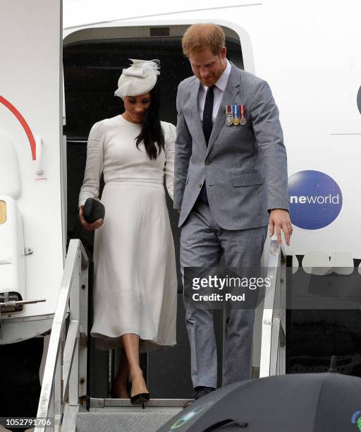 Prince Harry, Duke of Sussex and Meghan, Duchess of Sussex disembark from their plane on their arrival in Suva on October 23, 2018 in Suva, Fiji. The...