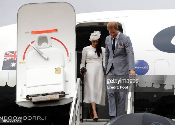 Prince Harry, Duke of Sussex and Meghan, Duchess of Sussex disembark from their plane on their arrival in Suva on October 23, 2018 in Suva, Fiji. The...