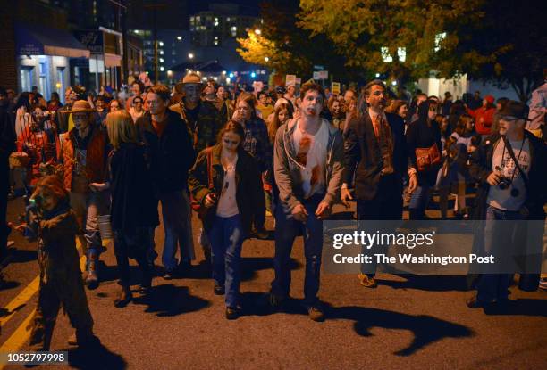 Citizens decked out as the undead fill Sligo avenue for the annual Zombie Walk on October 2013 in Silver Spring, MD.