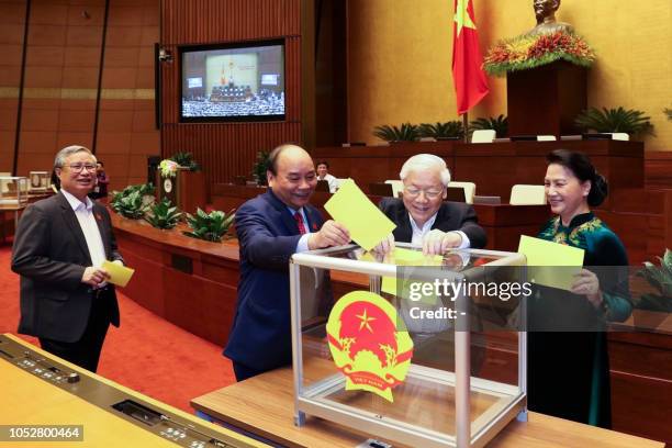 Vietnam communist party chief Nguyen Phu Trong casts his ballot to elect country's president at the National Assembly hall in Hanoi on October 23,...