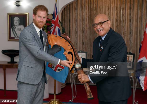 Prince Harry, Duke of Sussex receives a gift from the President of Fiji Jioji Konrote on the first day of their tour to Fiji on October 23, 2018 in...