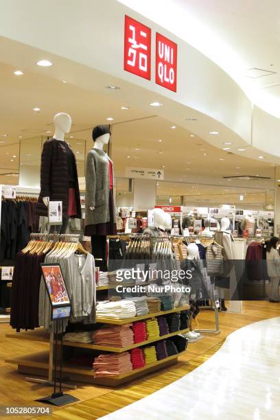 Shoppers look at items at Fast Retailing's Uniqlo store in Tokyo, Japan, October 23, 2018.