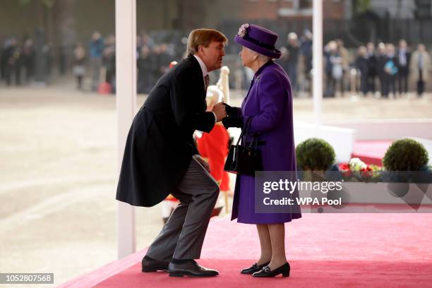 King Willem-Alexander of the Netherlands greets Queen Elizabeth II upon his arrival to inspect an honour guard during a Ceremonial Welcome on Horse...