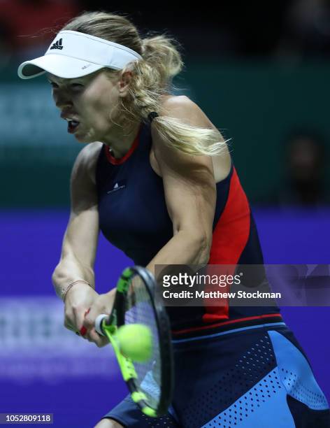 Caroline Wozniacki of Denmark plays a forehand in her singles match with Petra Kvitova of the Czech Republic prior to their singles match during day...