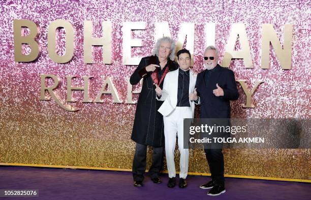Actor Rami Malek poses on the red carpet with British musician, and drummer of the rock band Queen, Roger Taylor and British musician, and lead...