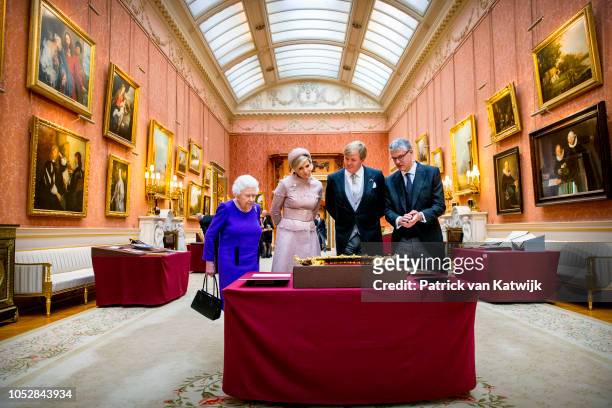 Queen Elizabeth II, Queen Maxima of The Netherlands, and King Willem-Alexander of The Netherlands visit the Picture Gallery in Buckingham Palace on...