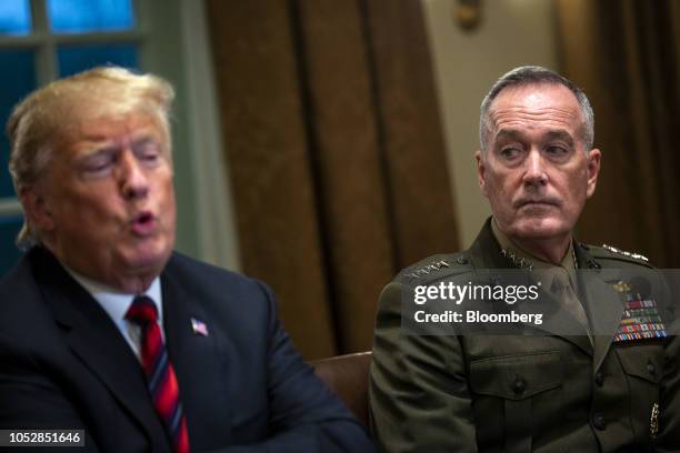 General Joseph Dunford, chairman of the Joint Chiefs of Staff, right, listens as U.S. President Donald Trump speaks during a briefing with senior...