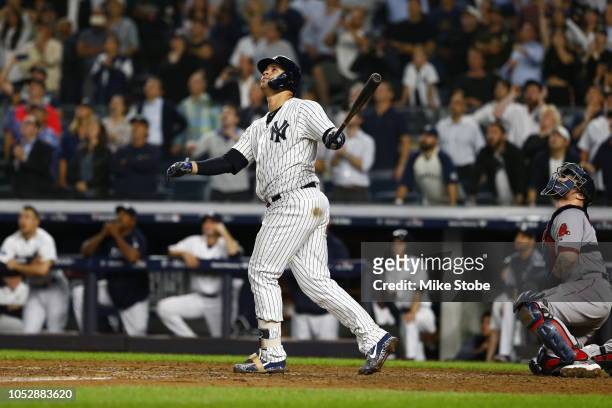 Gary Sanchez of the New York Yankees hits a sac fly to score Didi Gregorius against Craig Kimbrel of the Boston Red Sox during the ninth inning in...