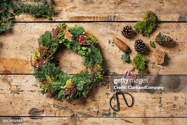 overhead view of christmas wreath or garland being made. - christmas denmark stock pictures, royalty-free photos & images