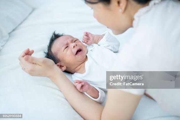 crying baby - moms crying in bed stock pictures, royalty-free photos & images