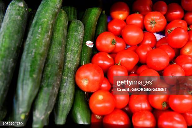 Organic cucumbers and tomatoes are on sale in an organic supermarket in Saintes, western France, on October 23, 2018. - According to the public...