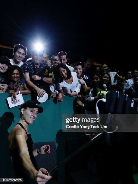 Angelique Kerber of Germany takes a selfie with fans after winning in her women's singles match against Naomi Osaka of Japan during day 4 of the BNP...