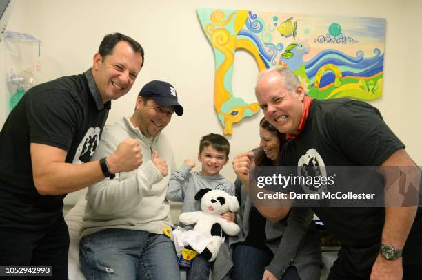 Major League Baseball umpires Jim Reynolds and Tim Timmons take a picture with Nathaniel, Mom and Dad at Boston Children's Hospital October 24, 2018...