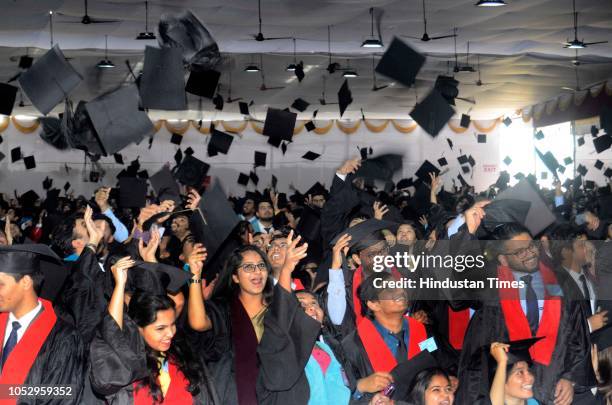 Students of Symbiosis deemed University throw their caps after 15th convocation of Symbiosis, Lavale campus on October 23, 2018 in Pune, India.