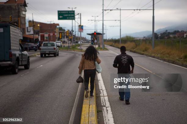 People walk on a street in Merida, Venezuela, on Friday, Sept. 28, 2018. Rangel hanged himself on July 20, 2016. Suicides are rapidly rising across...