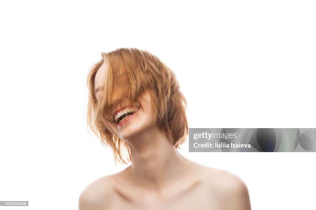 Young lady with freckles smiling in studio