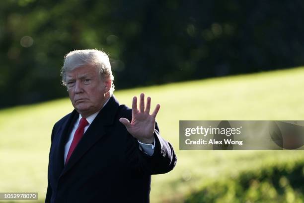 President Donald Trump waves as he walks towards the Marine One on the South Lawn of the White House prior to his departure October 24 2018 in...