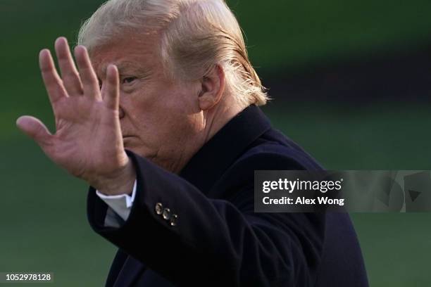 President Donald Trump waves as he walks towards the Marine One on the South Lawn of the White House prior to his departure October 24 2018 in...