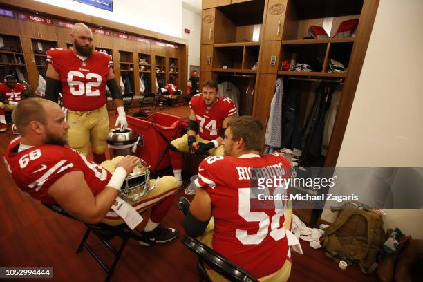 Mike Person, Erik Magnuson, Joe Staley and Weston Richburg of the San Francisco 49ers talk in the locker room prior to the game against the Arizona...
