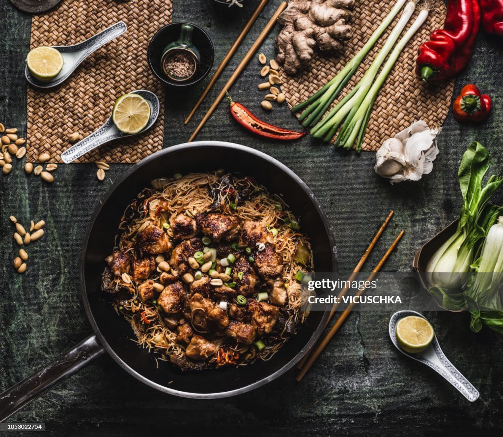 Wok with cellophane or glass noodles and teriyaki chicken stir fry , top view