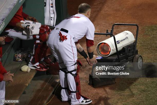 Boston Red Sox catcher Christian Vazquez warms up his hands in the bullpen before the game. The Boston Red Sox host the LA Dodgers in Game Two of the...