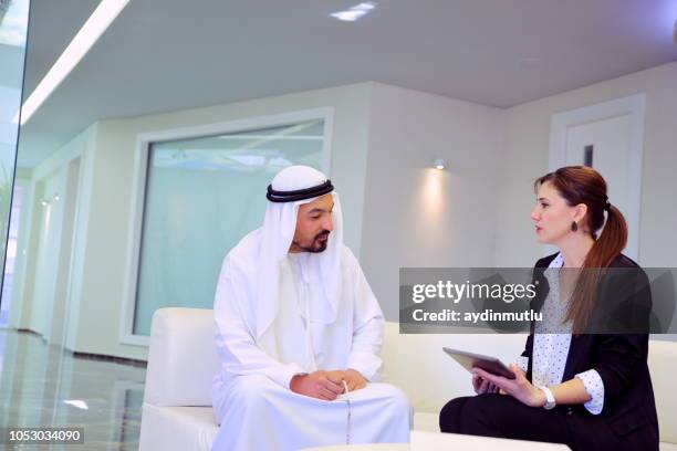 arab businessman and cooperation woman - qatar stock pictures, royalty-free photos & images