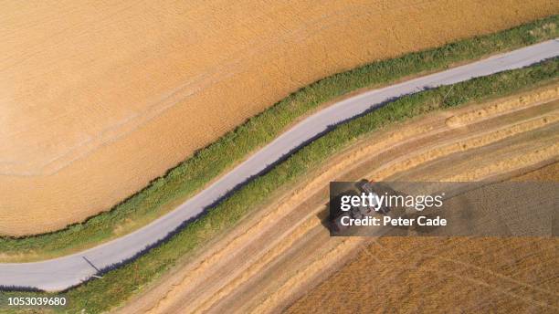 tractor in field cutting grass for hay - wheat field from above stock pictures, royalty-free photos & images