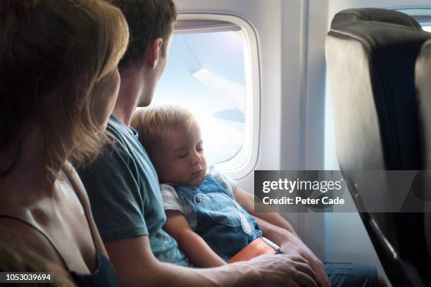 mother, father and baby son on airplane - couple airplane stock pictures, royalty-free photos & images